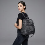 Black Leather Backpack with Triangular Metal Accent